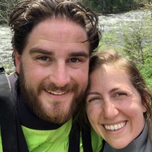 Ian and Megan the owners of Zoo Town Surfers are smiling with the Lochsa River in the background.