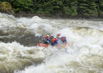 Overnight Trips 5 Zoo Town Surfers raft charging through a massive whitewater rapid on the Lochsa River.