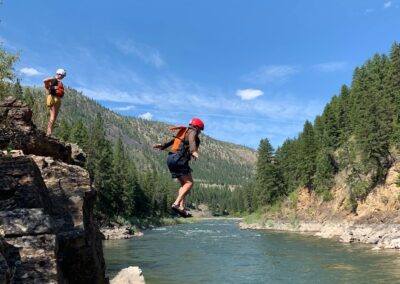 Missoula whitewater rafting cliff jumping into the river.