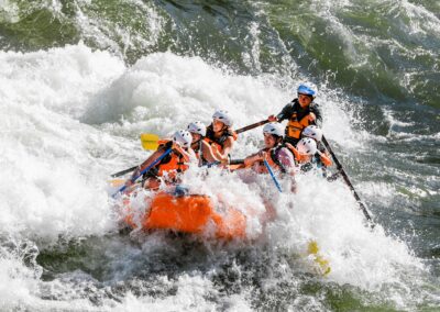 Missoula whitewater rafting trip on the Alberton Gorge in orange raft.