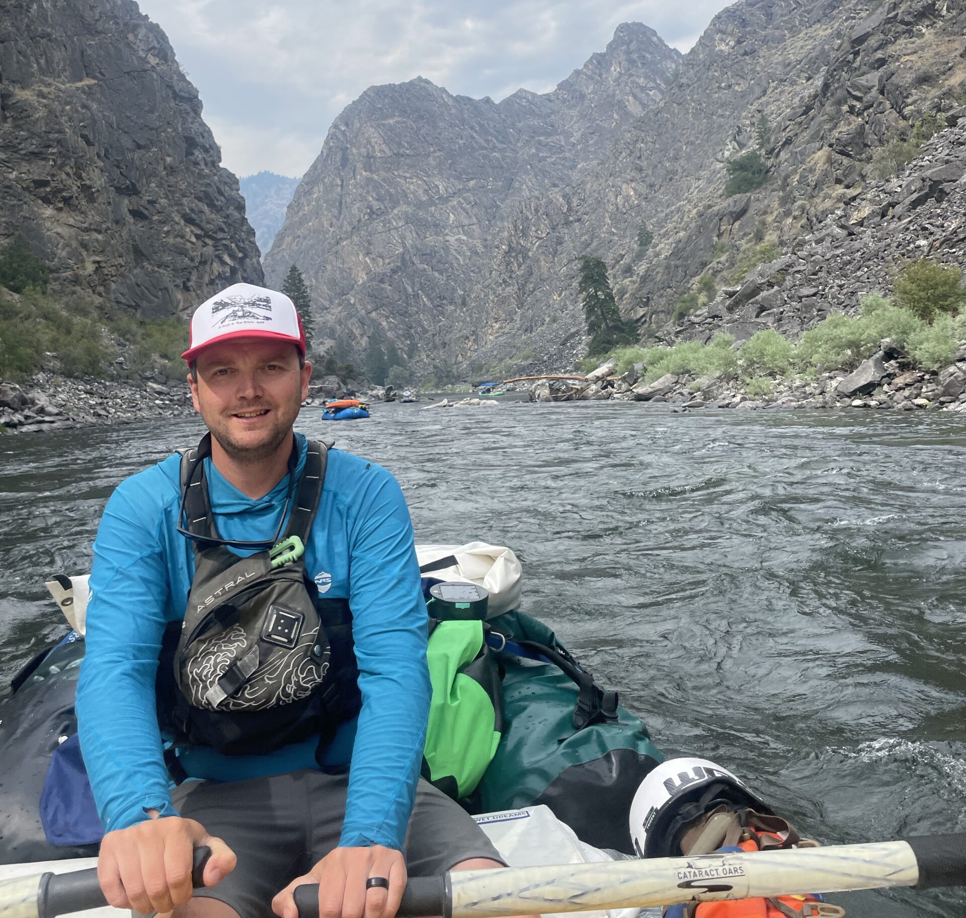 RiverHS Ian and Megan the owners of Zoo Town Surfers are smiling in their drysuits with the Lochsa River in the background.