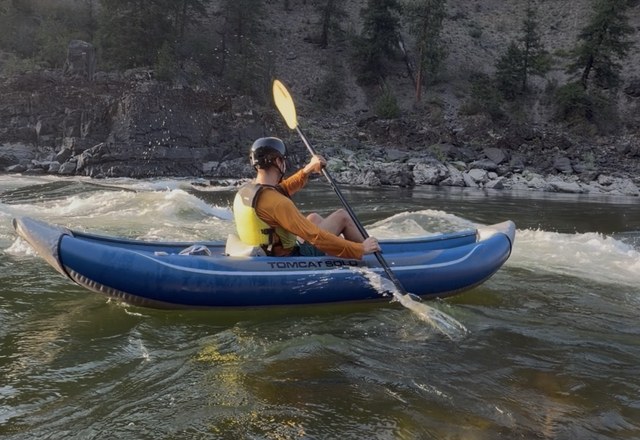 Alberton Gorge Full Day Inflatable Kayaking Kayaker paddling an inflatable kayak through whitewater rapids on the Alberton Gorge full day inflatable kayaking trip near Missoula, Montana