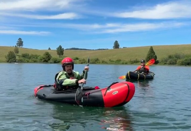 Packrafting Private Lesson Instruction Two packrafters practicing paddle technique during a private packrafting lesson on a Montana lake