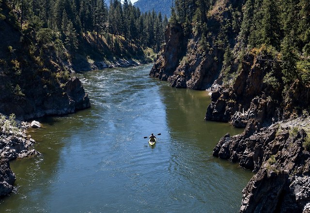 Tarkio Gorge Half Day Inflatable Kayaking Kayaker paddling an inflatable kayak through the Tarkio Gorge canyon on a half day inflatable kayaking trip near Missoula, Montana